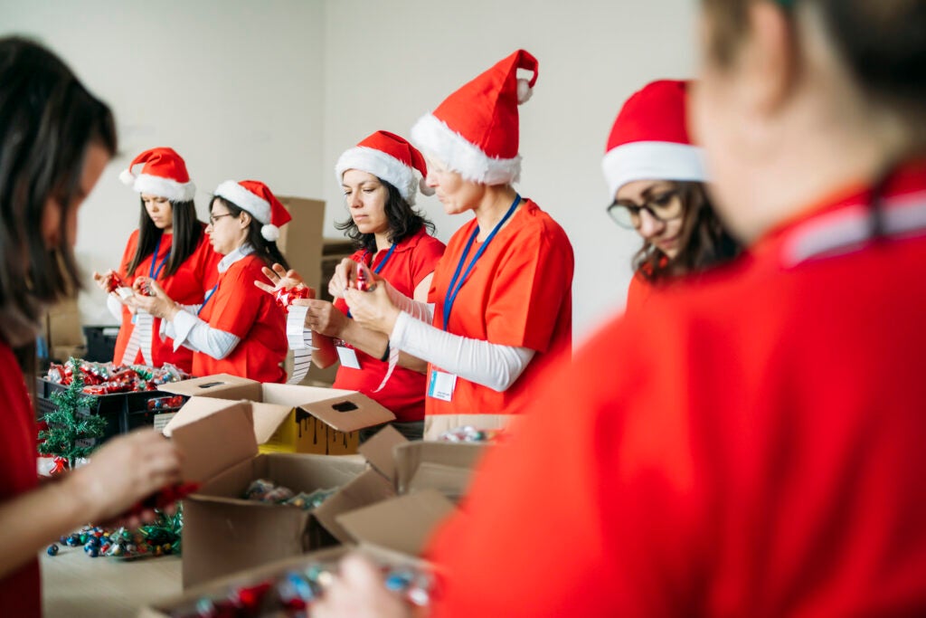A group of volunteers preparing presents for a Christmas fundraising activity.